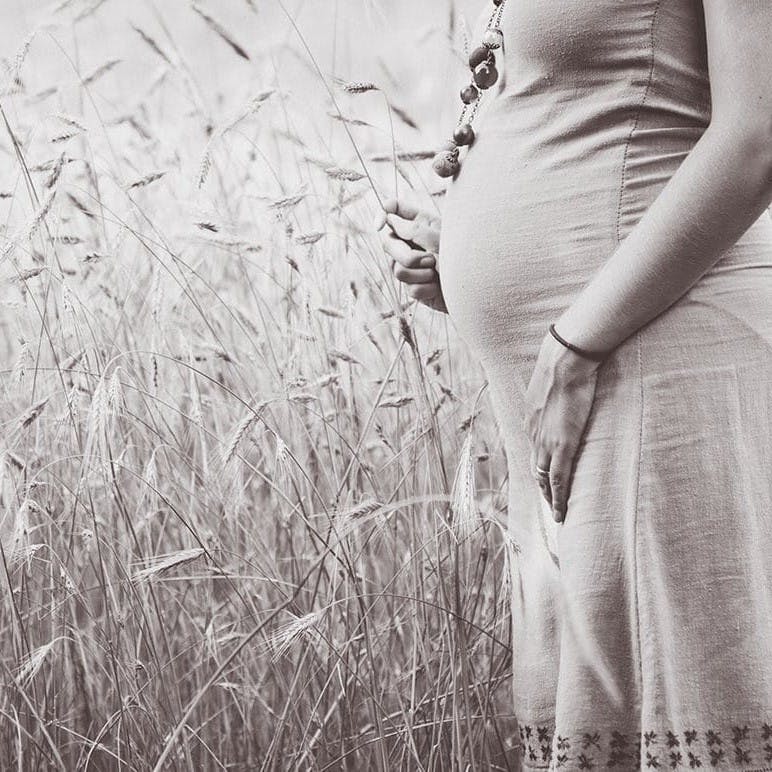 Pregnant women in field.