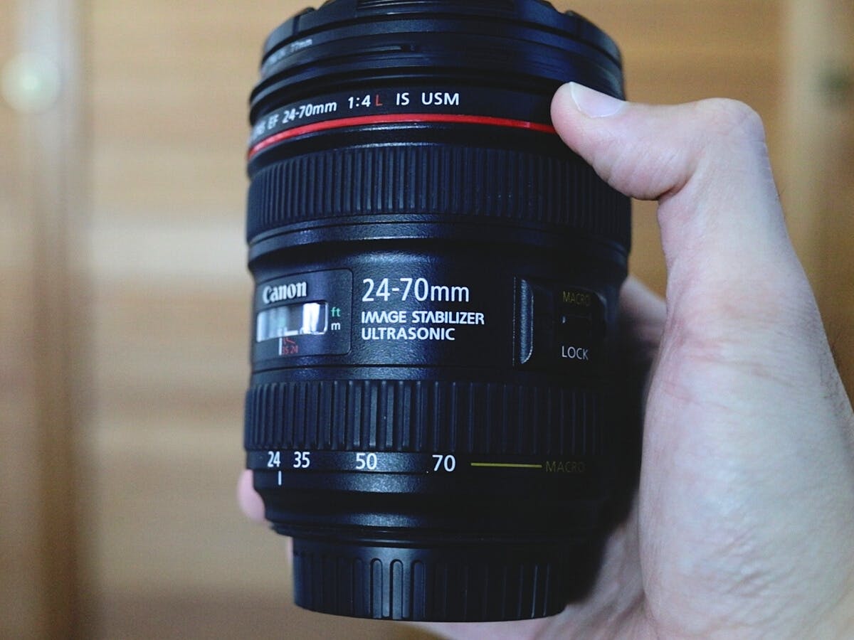 Holding the Canon EF 24-70mm f/4L.