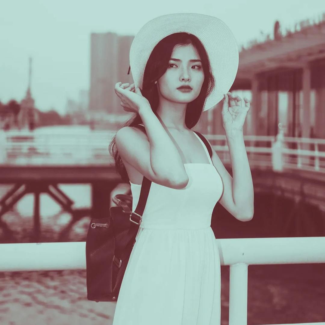Woman with hat and black backpack in white dress.