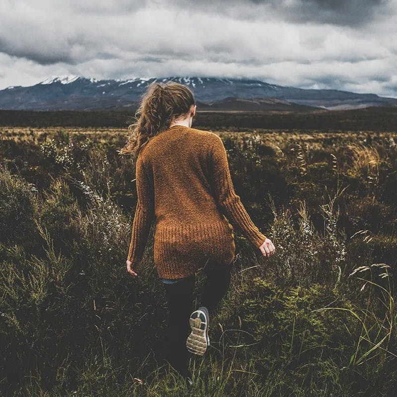 Woman walking in a field.
