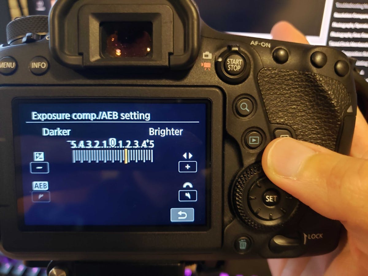 Adjusting exposure compensation on the back of a camera to +2.