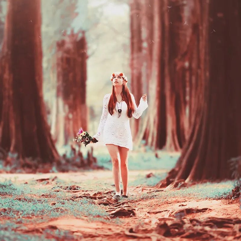 Girl standing in forest.