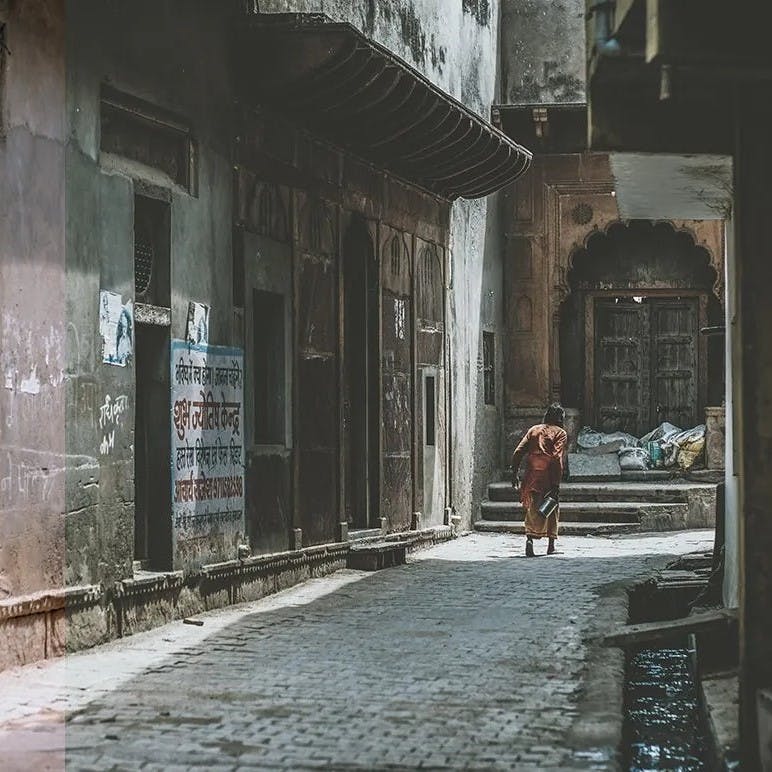 Old man walking down empty street.