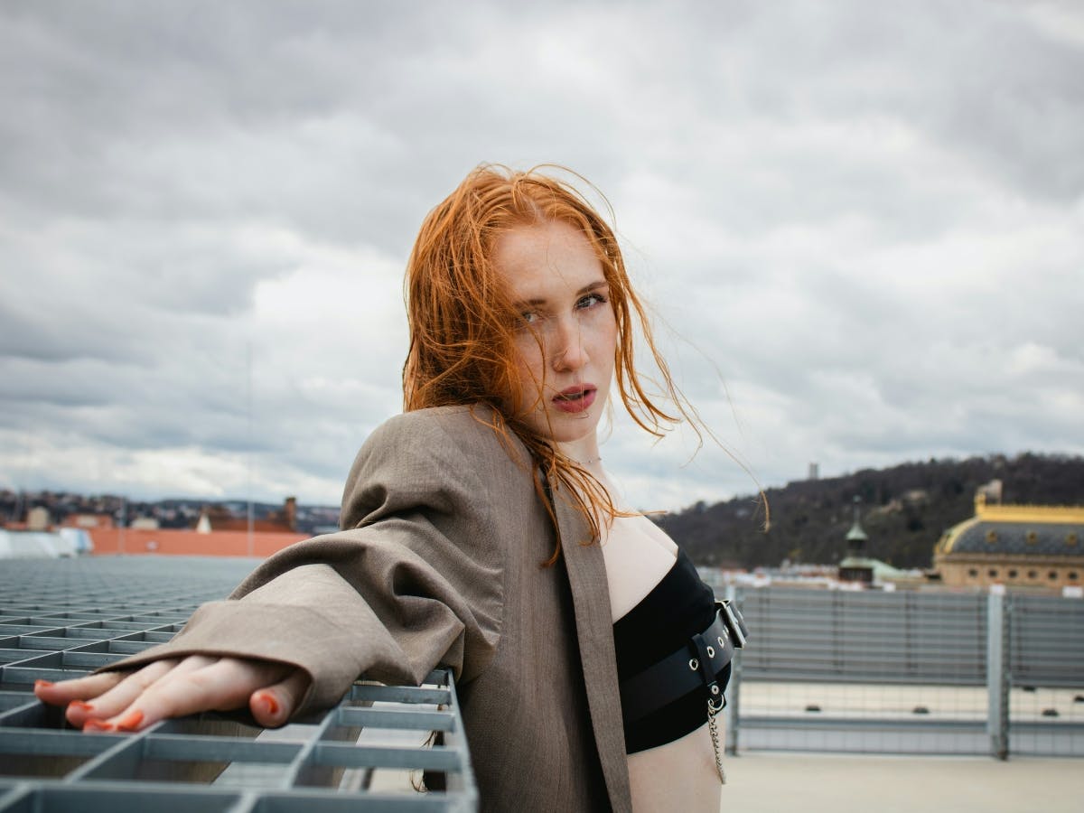 Fashion photo of red head girl on a rooftop.