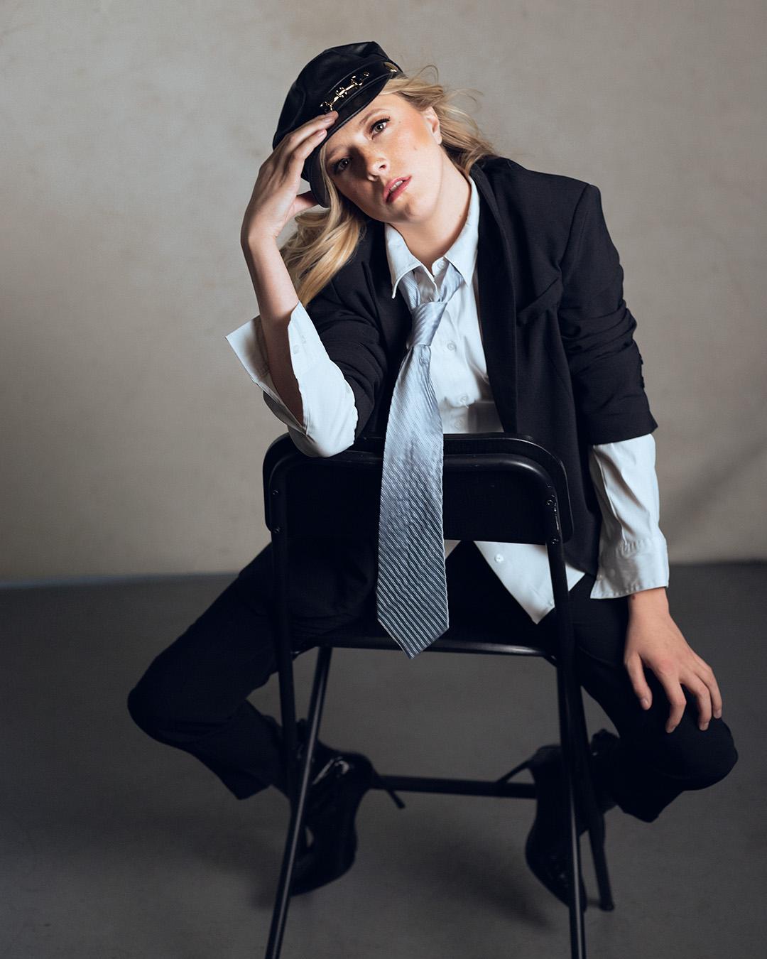 Fashion photo of girl sitting on chair backwards.