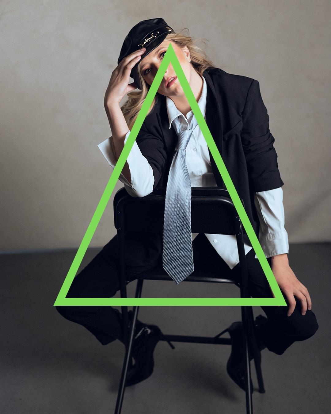 Fashion photo of girl sitting with triangle overlay.