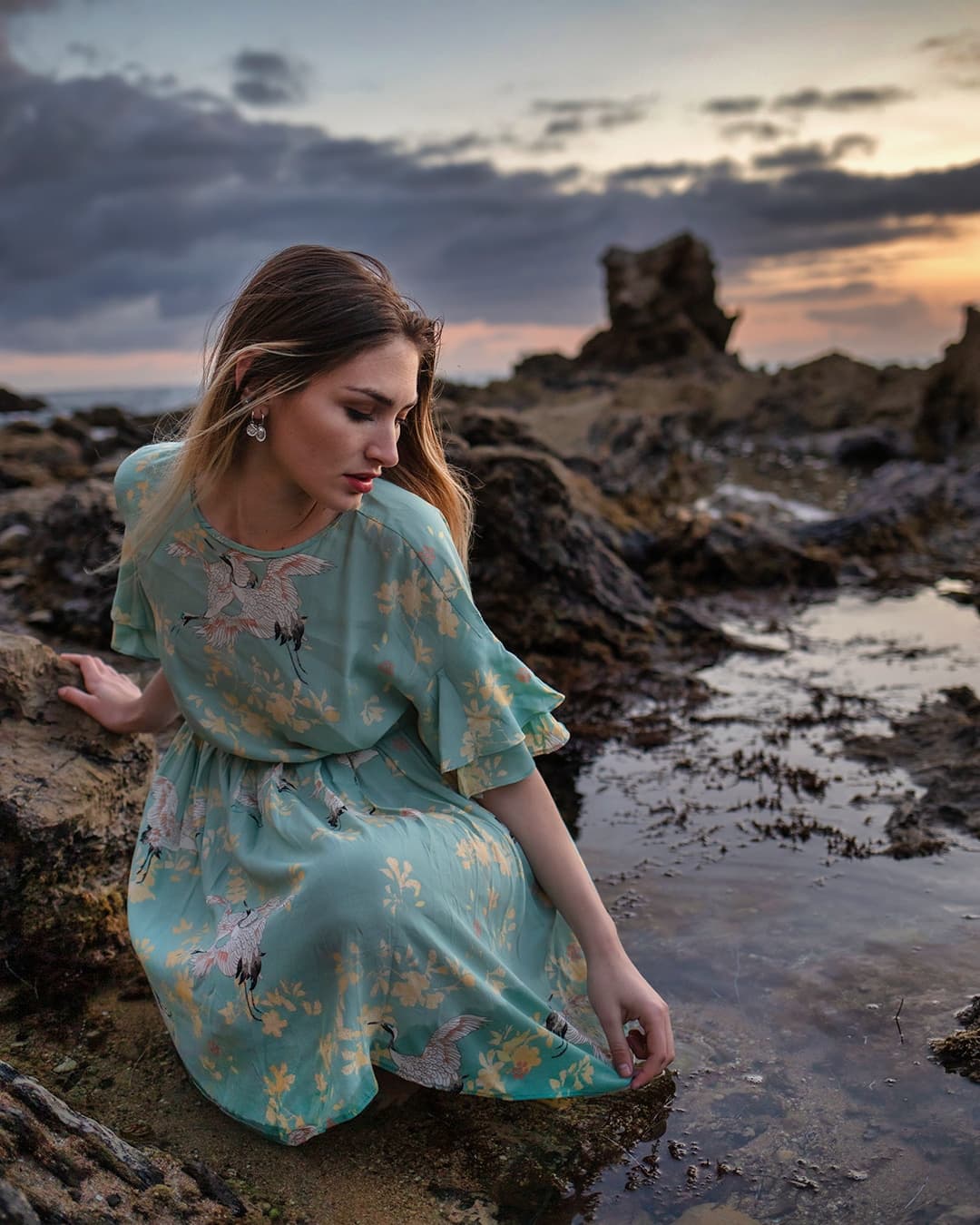 Example fine art portrait of a girl touching water.