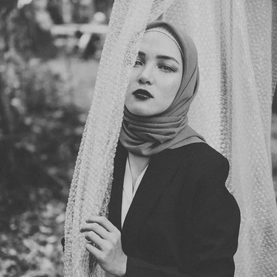 Woman in hijab looking at camera.