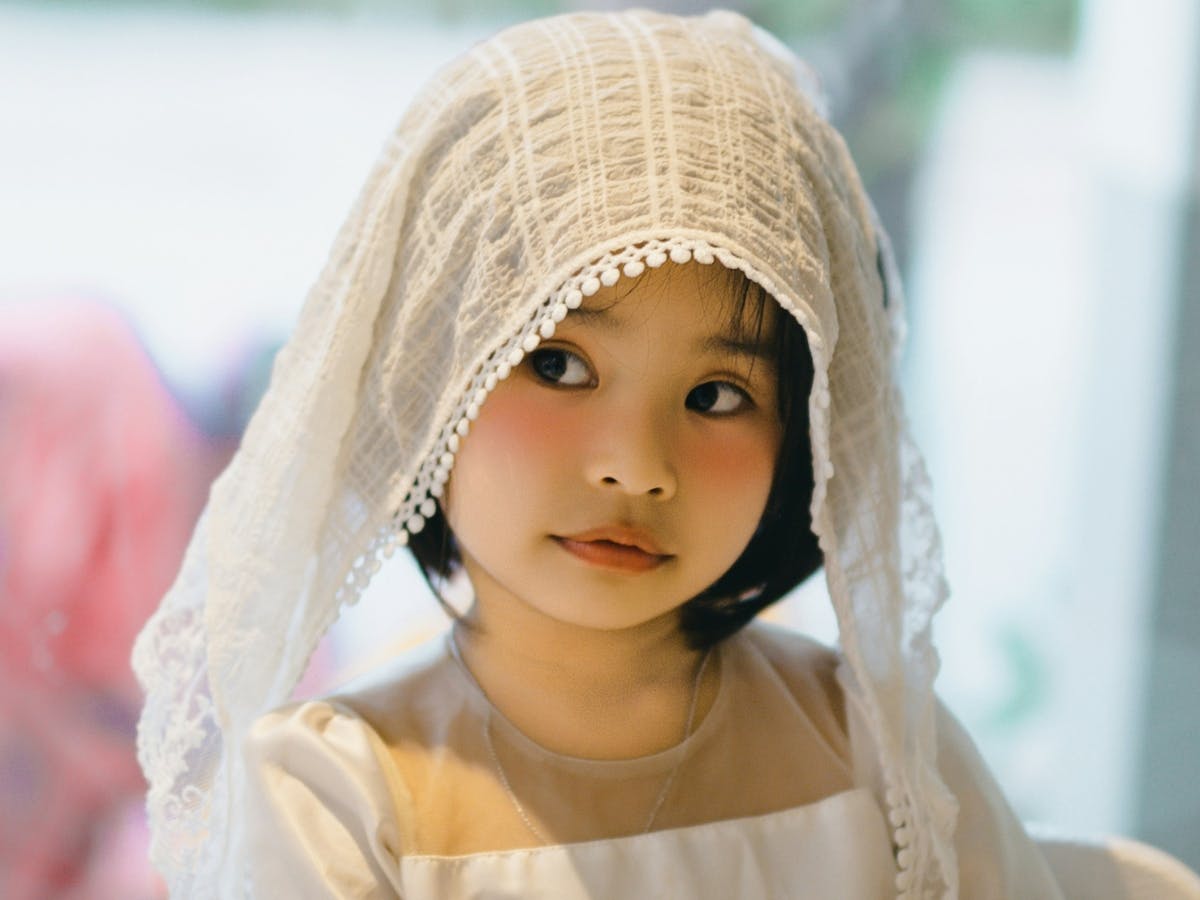 Kids headshot of girl in white dress.