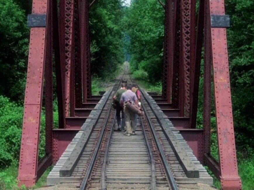 Scene from Stand by Me when kids are walking on train tracks that are leading lines.