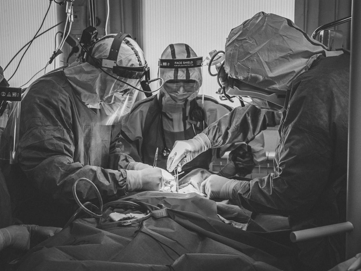 Doctors working on patient in a medical photo.