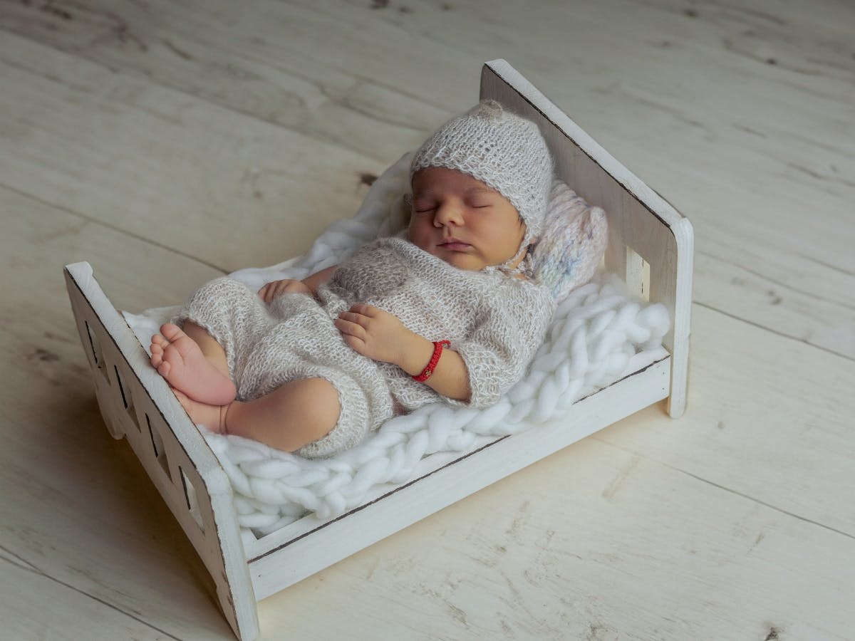 Photo of a newborn in a bed.