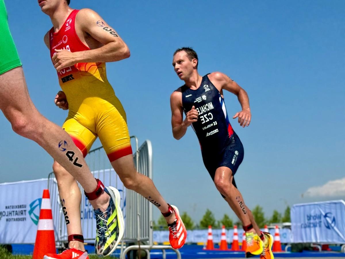 Man running a race from a low vantage point.