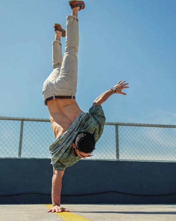 Man doing handstand on leading line.
