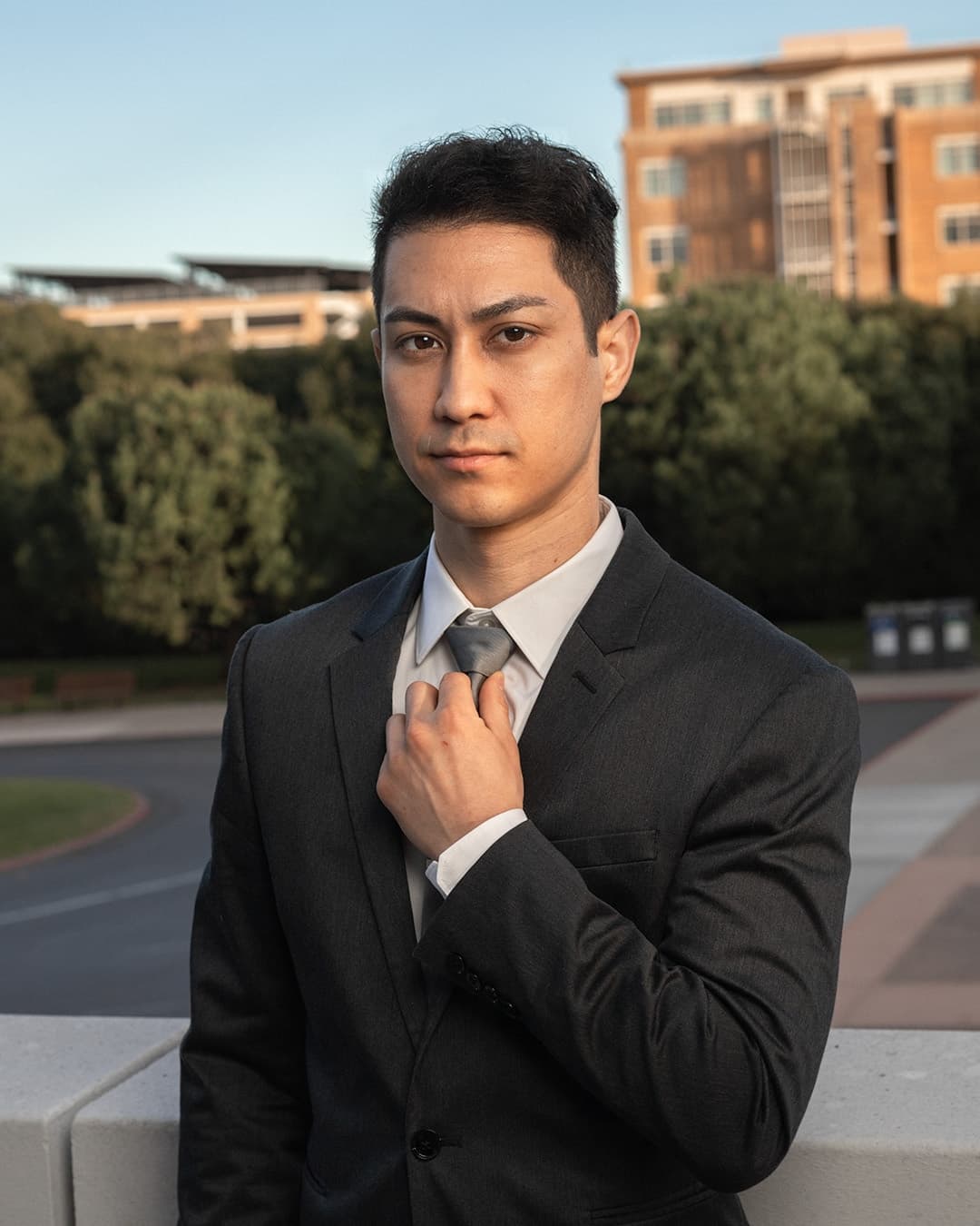 Adjusting tie male pose Man posing in suit adjusting his tie.