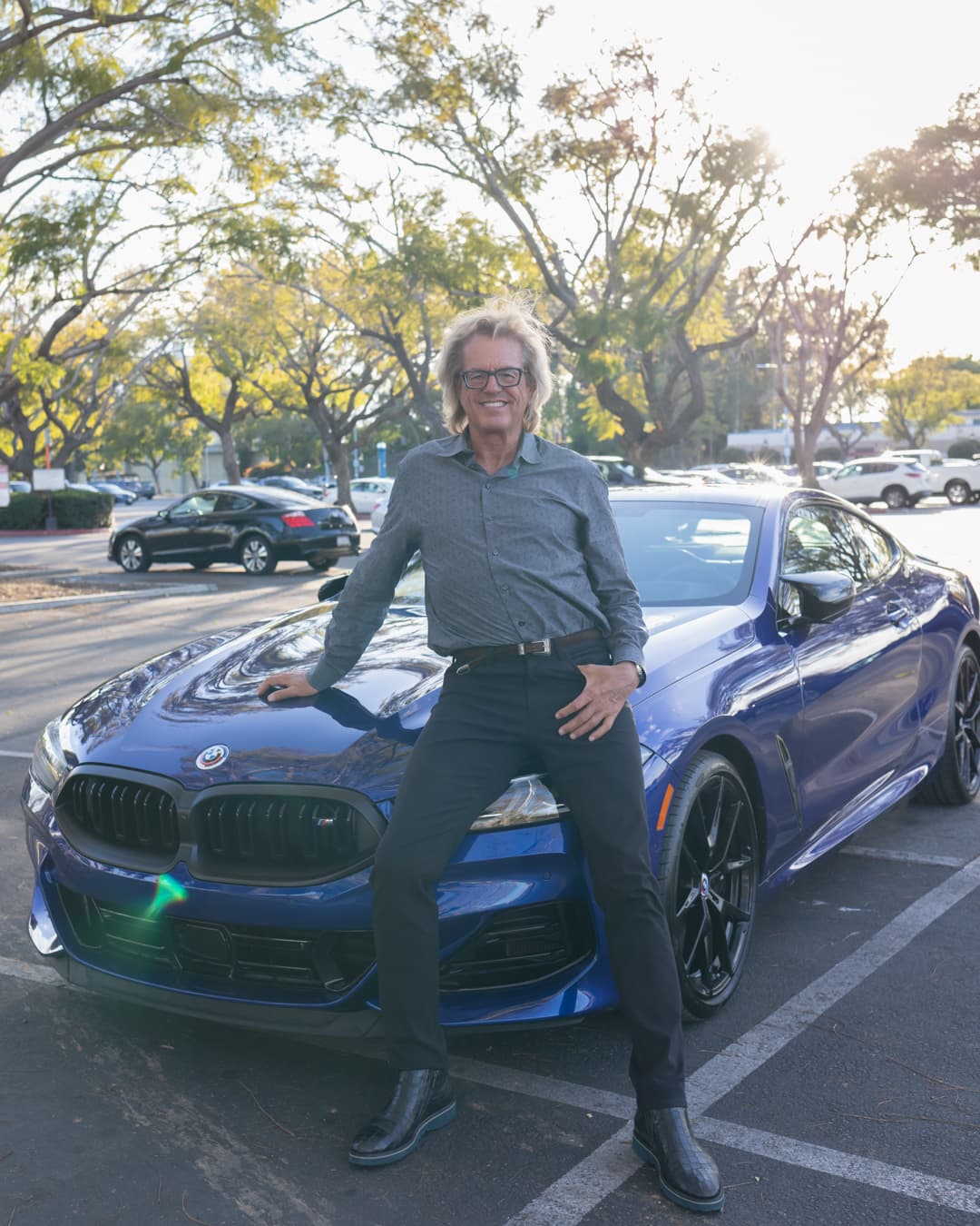 Balance out overexposure by reducing highlights Man sitting on car in an overexposed photo.