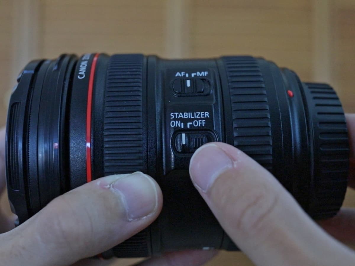 Canon EF 24-70mm f4L ISM image stabilization switch Canon EF 24-70mm f4L ISM image stabilization switch in my hands.