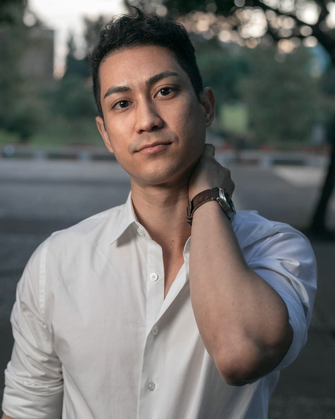 Hand on neck male pose Man posing in white dress shirt with hand on neck.