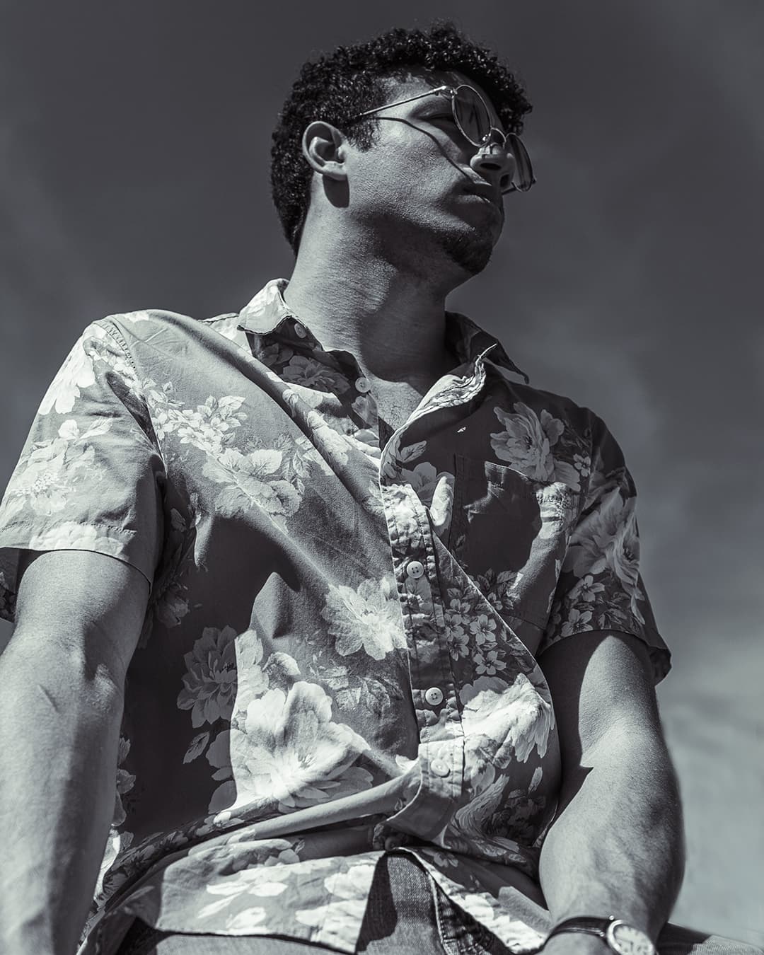 Portrait using hard light Black and white photo of man in flower shirt during hard light.