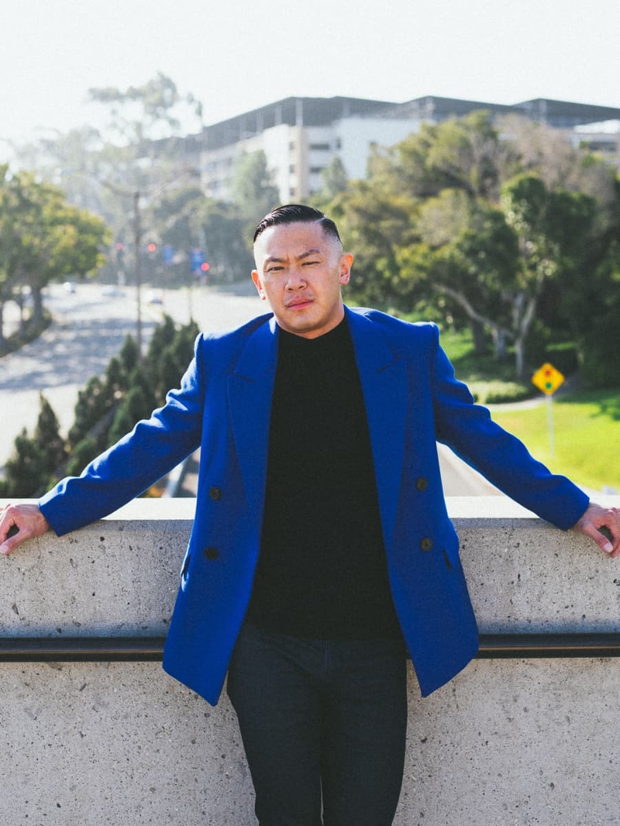 Leaning both hands spread male pose Man posing in blue suit with both hands spread.