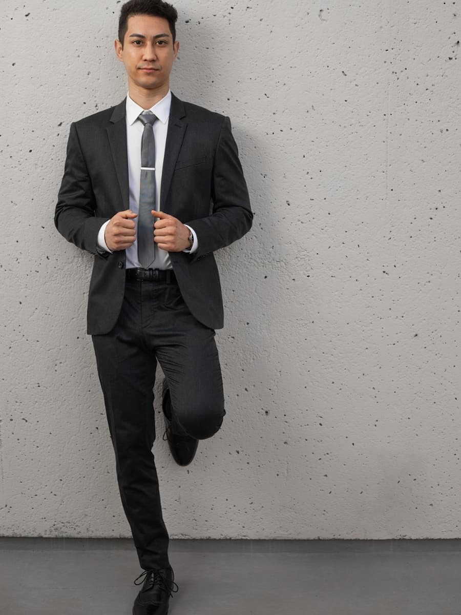 Leaning on wall (front) male pose Man posing in suit face forward leaning on wall.