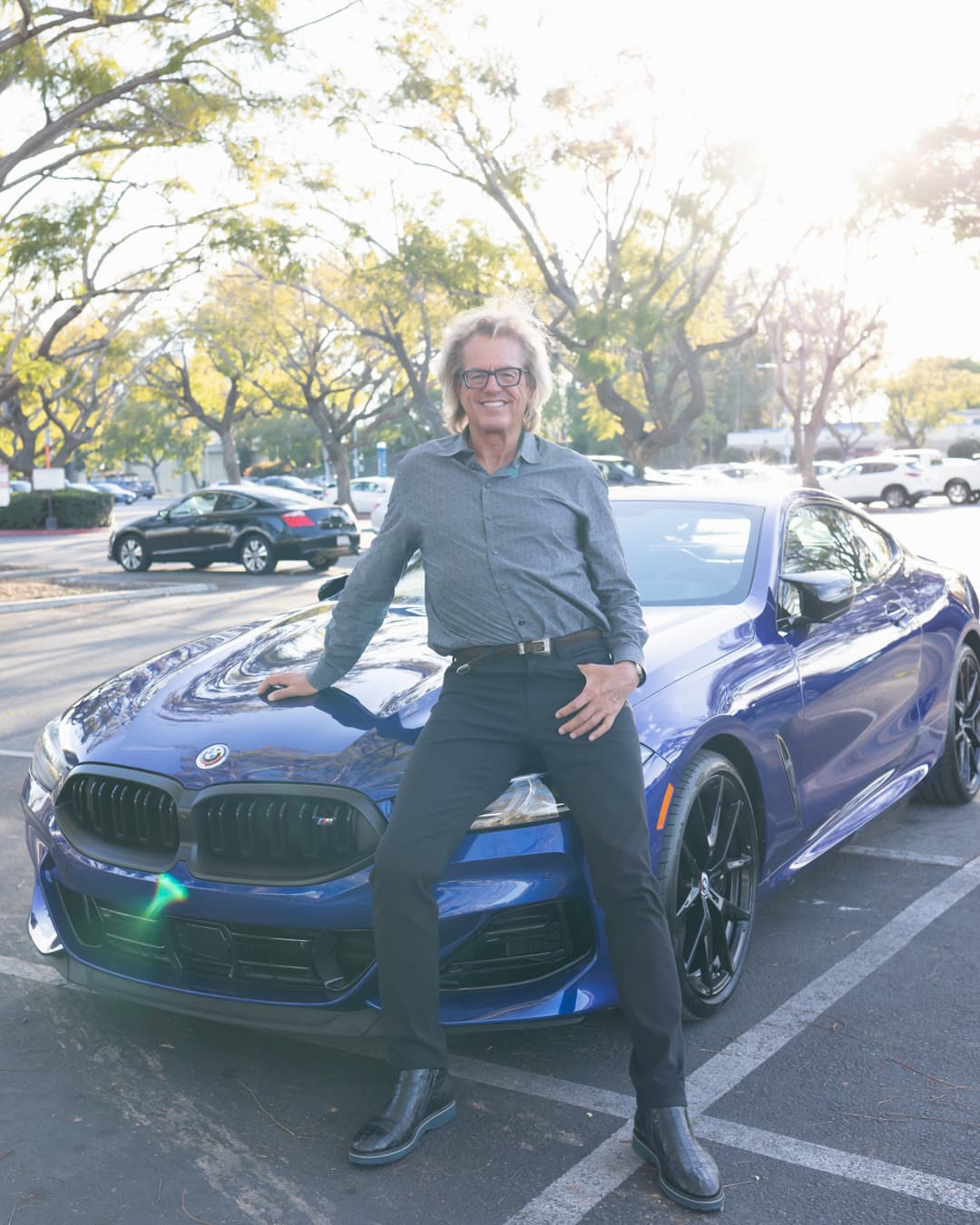 Metered on subject sky is overexposed Man sitting on car in an overexposed photo.