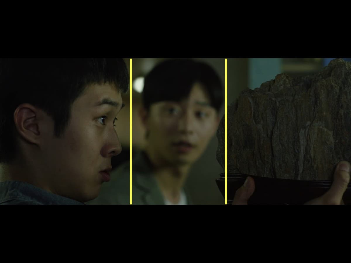 Parasite scene 3 - framing composition Composition from scene from Parasite where Ki-Woo is gifted scholar's rock.
