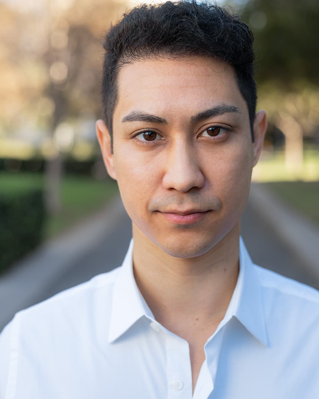 Headshot photography example Headshot photo of man in white shirt.