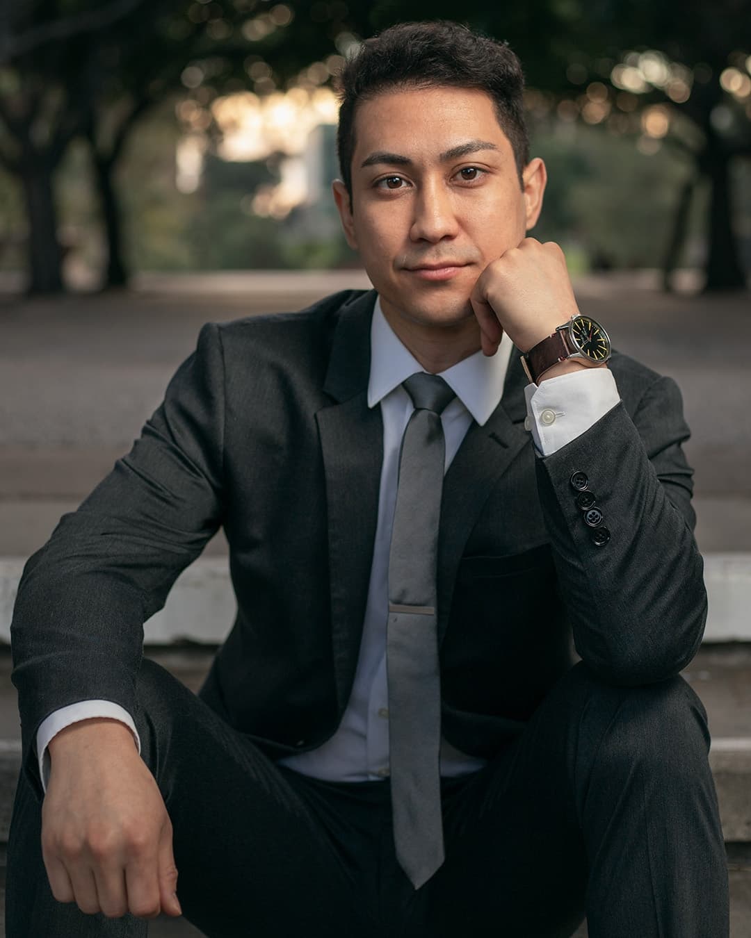 Sitting one hand on chin male pose Man posing in suit sitting one hand on chin.