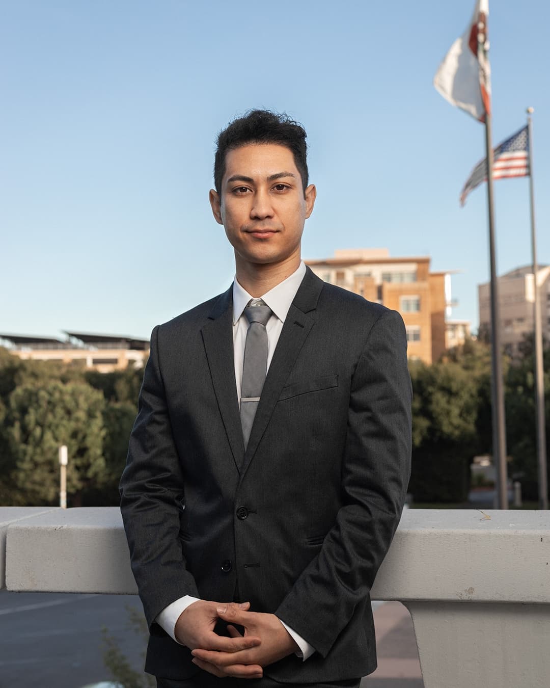 Standing hands grasped male pose Man posing in suit standing with his hands grasped.